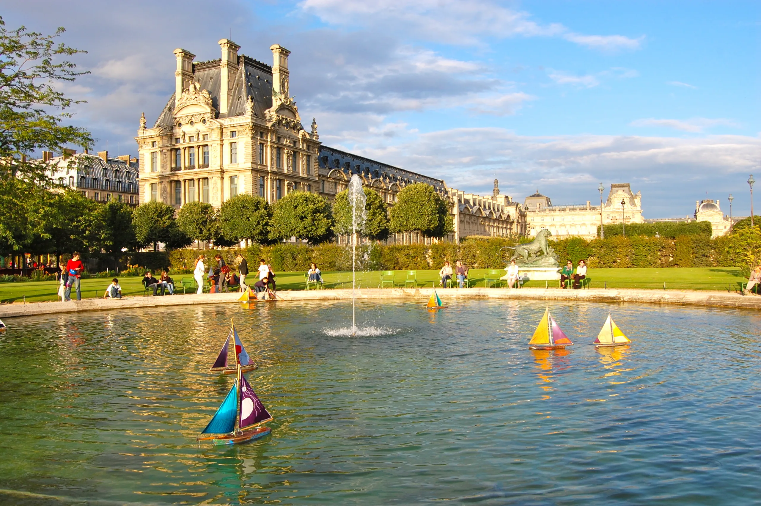 Children playing with sail boats on the lake in Tuilleries gardens, Paris