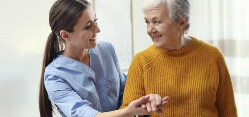 Domiciliary care Female carer assisting elderly woman service user